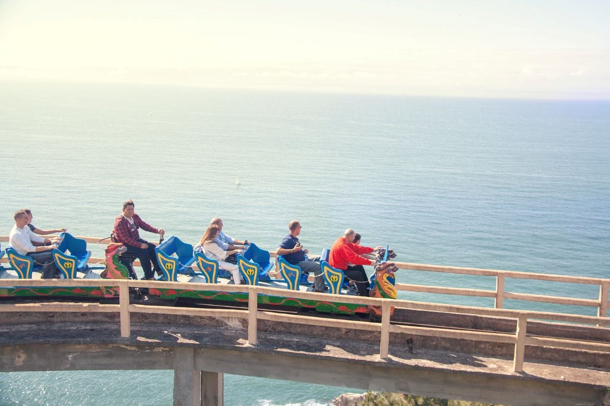 A family riding a roller coaster at an amusement park at Monte Igueldo.