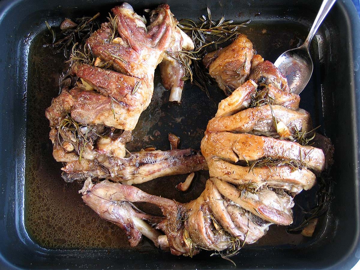large roasting pan filled with sliced roasted lamb.