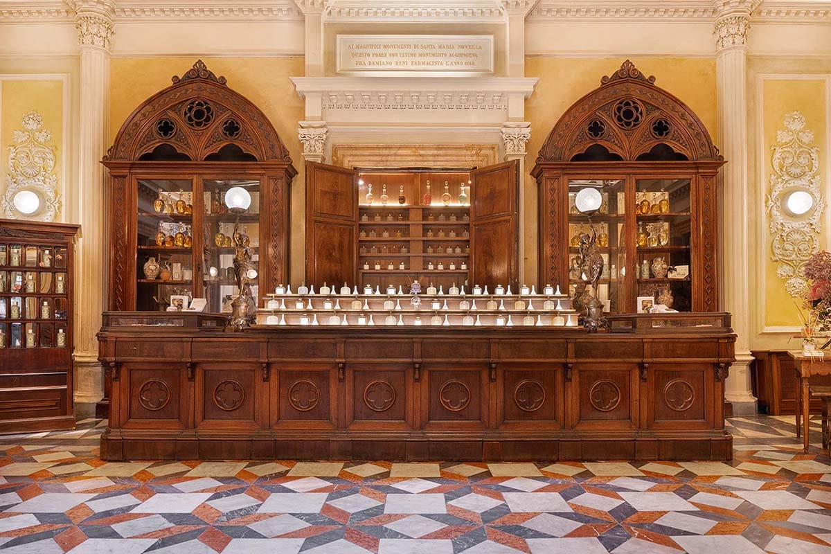 large historic building with shelves of products behind a large wooden desk.