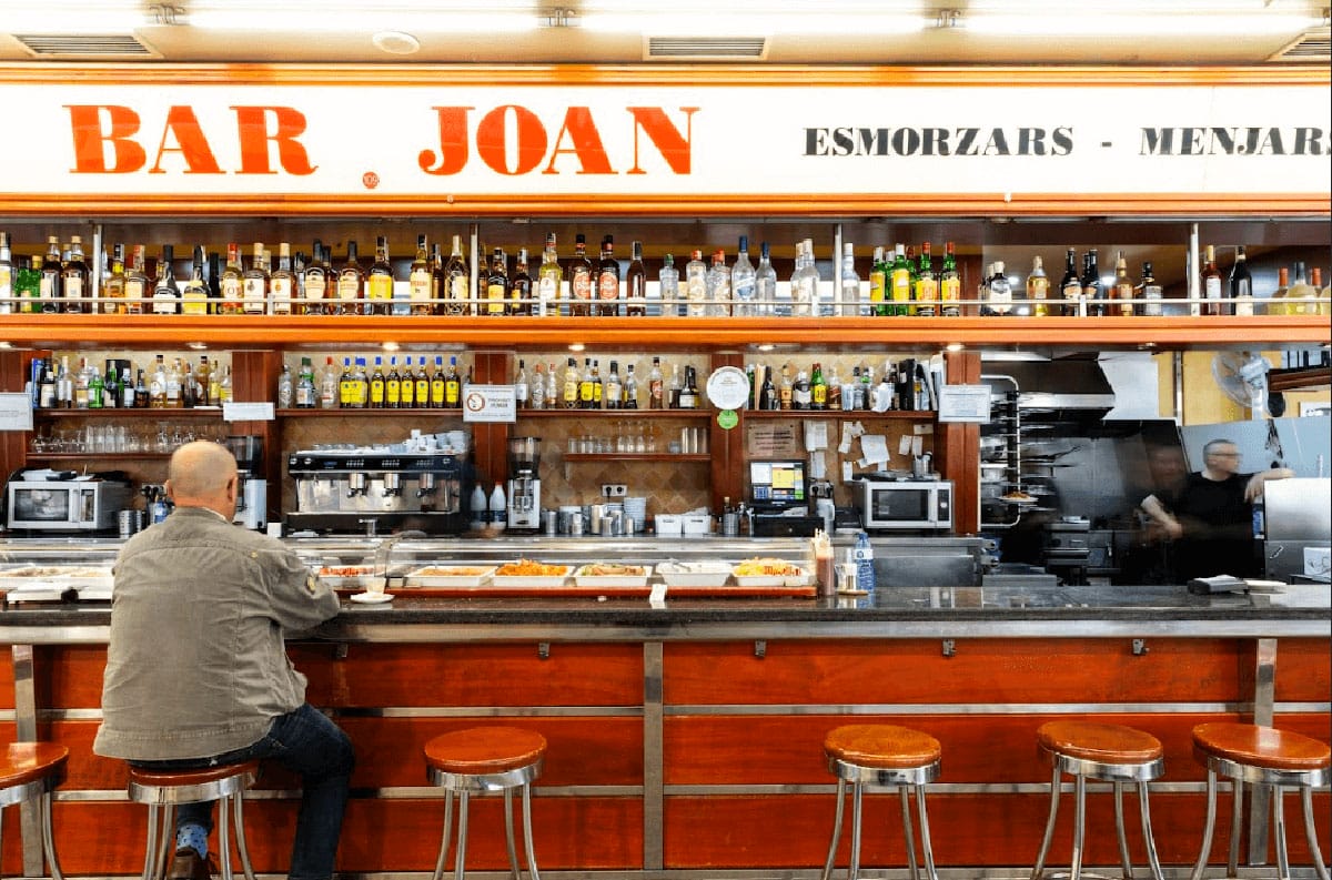 man sitting on a bar stool at Bar Joan.