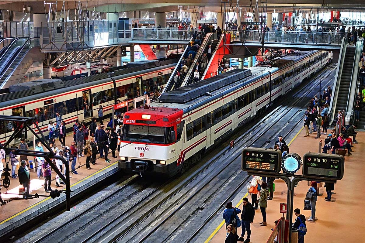 high speed train stopped at a busy train station.