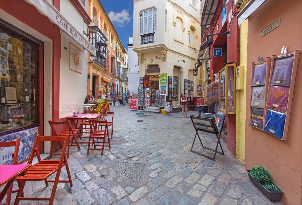 tables and chairs in narrow streets in Seville.