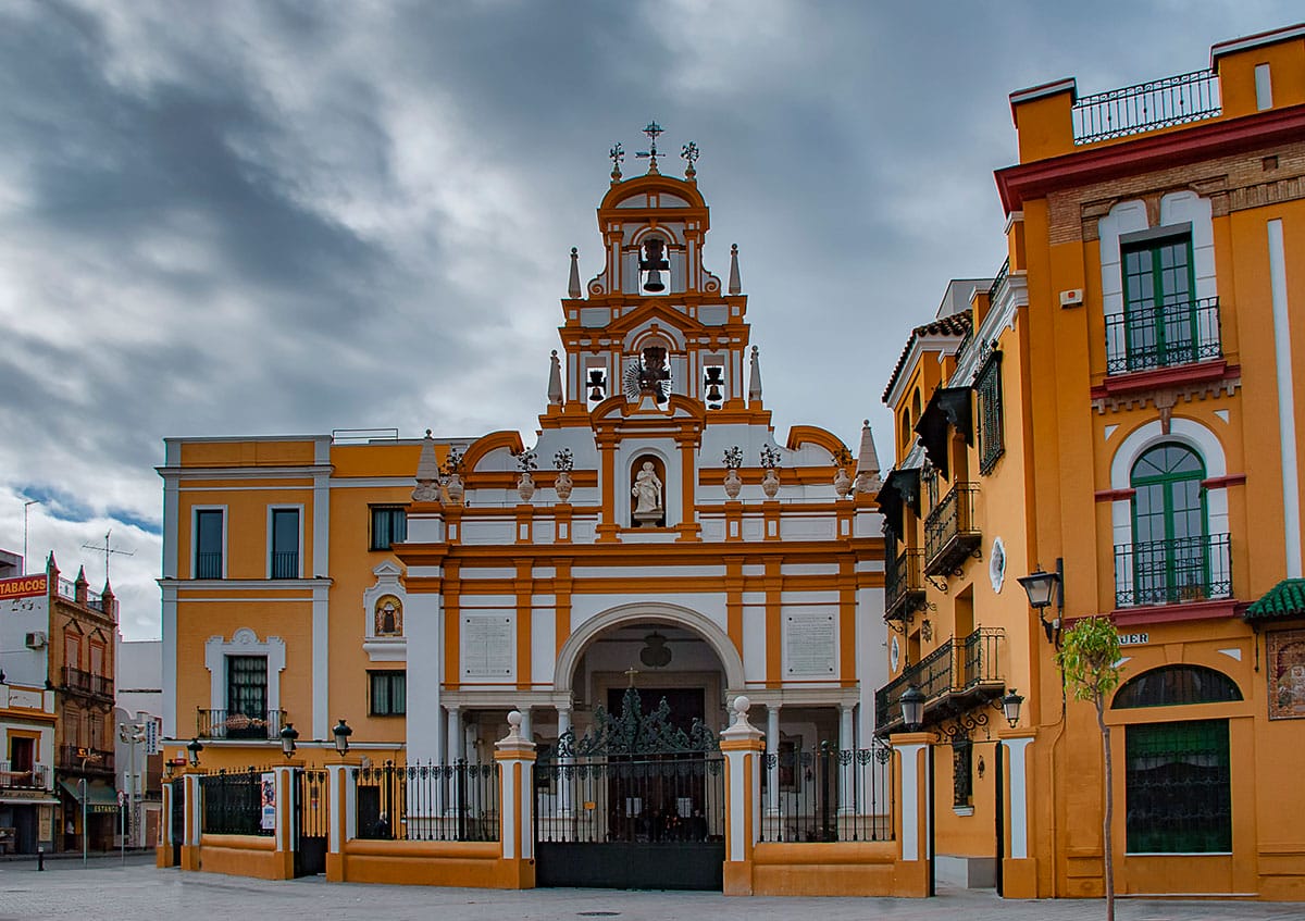 a large orange and white building with a bell tower.