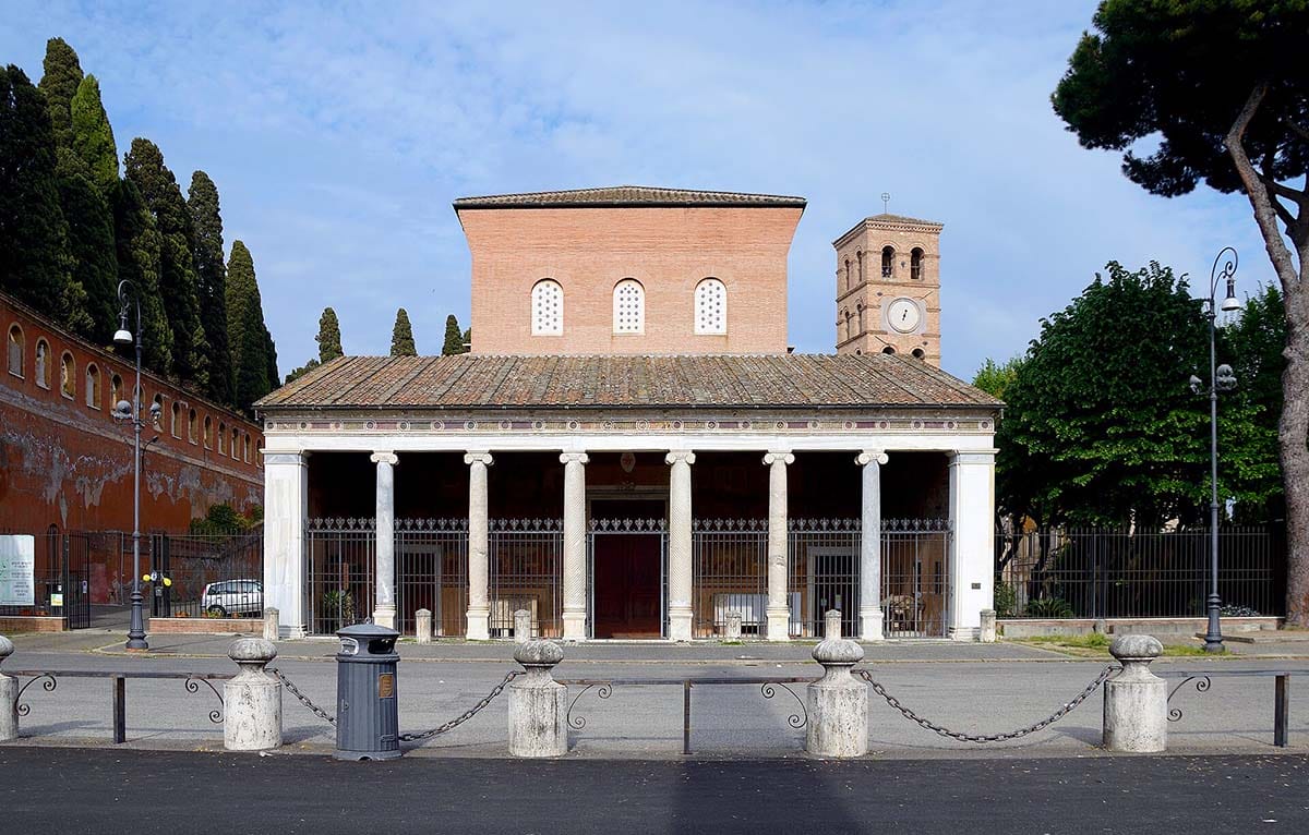 brick exterior and columned portico of a basilica.