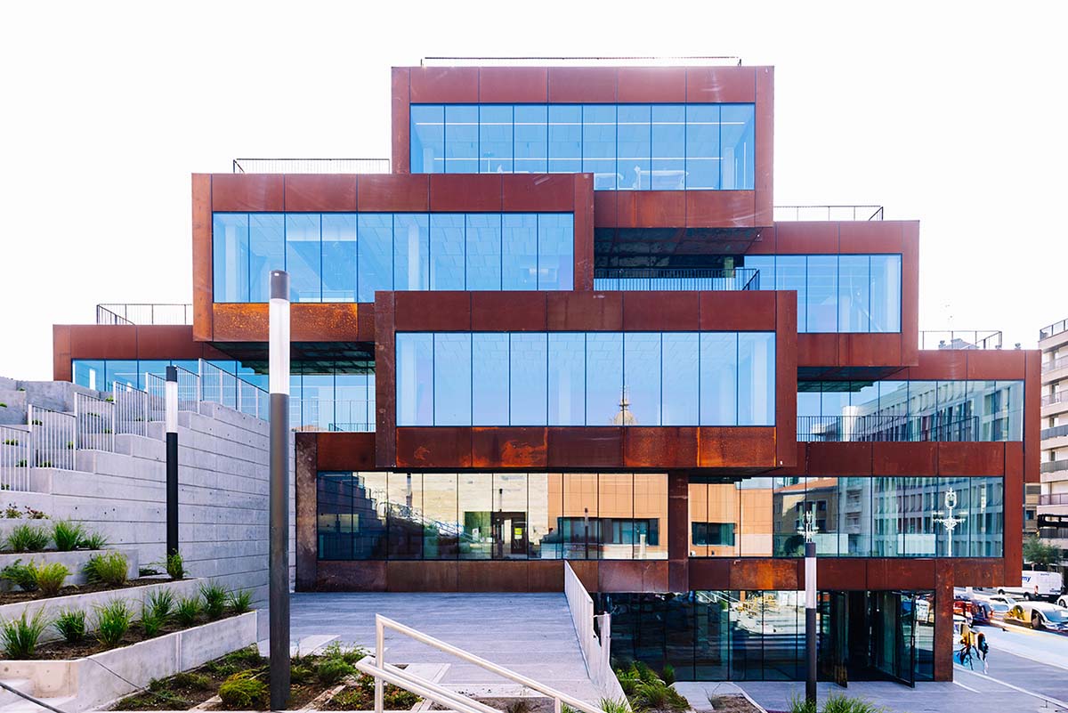 modern wooden building with lots of windows.