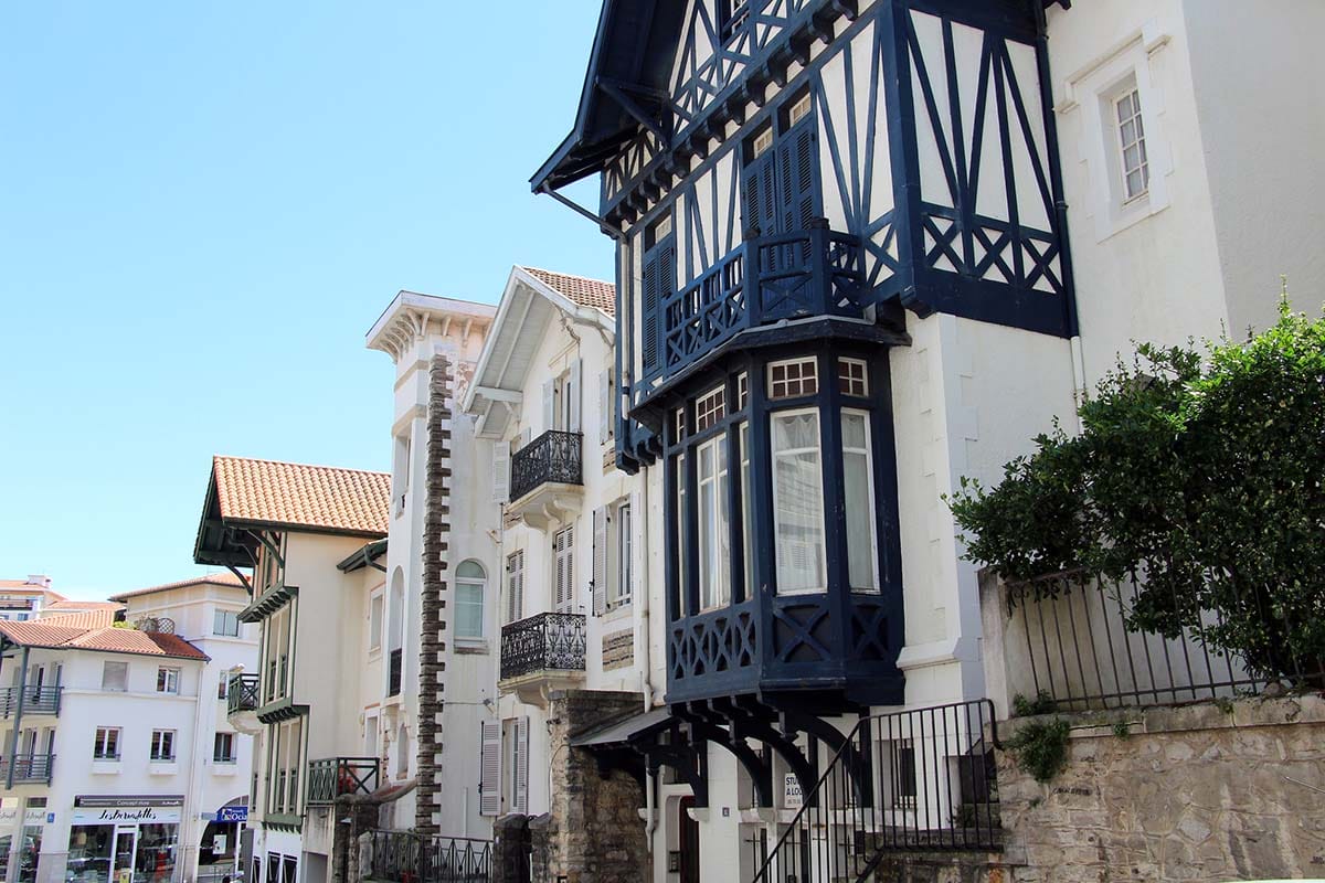 row of three-story homes on a sunlit street.