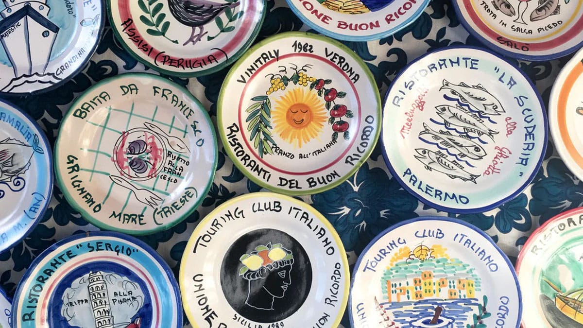 colorful, hand painted ceramic plates on a table.