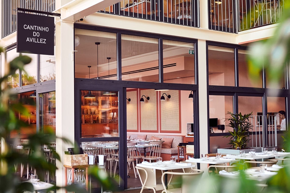 tables and chairs in a restaurant with large windows and a balcony.