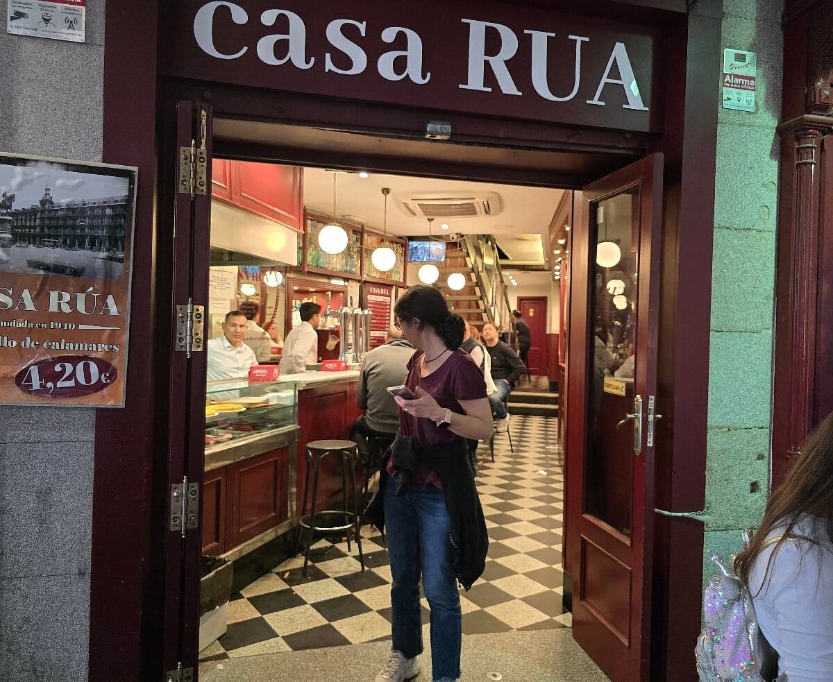girl walking out of a restaurant in Madrid.