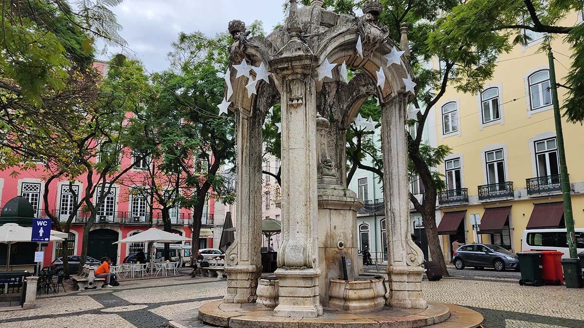 large statue in a tree-lined square in Lisbon.