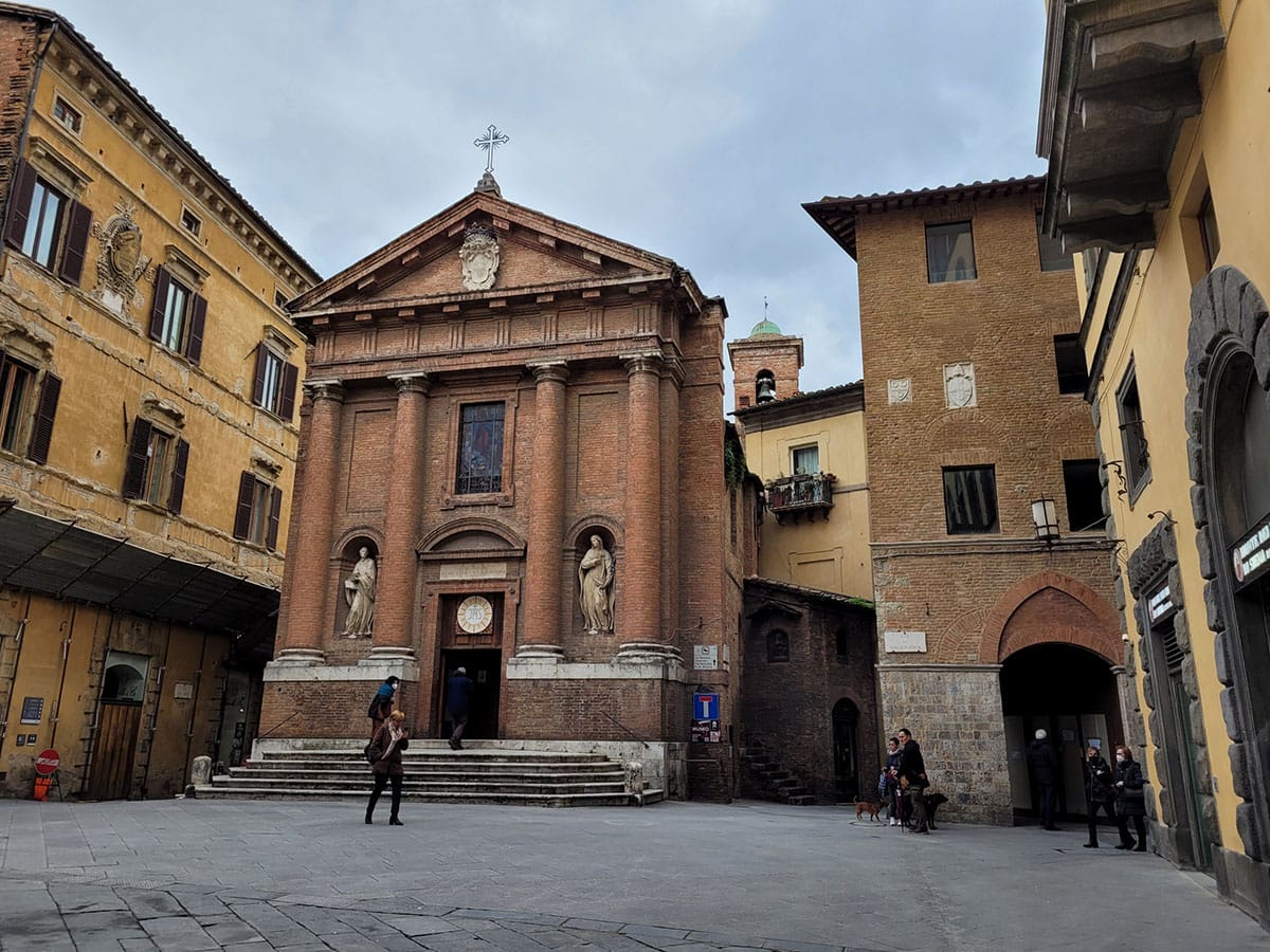 large brick church with steps leading to the doorway.