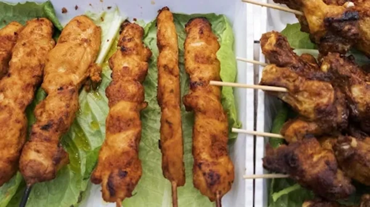 small meat skewers on lettuce leaves.