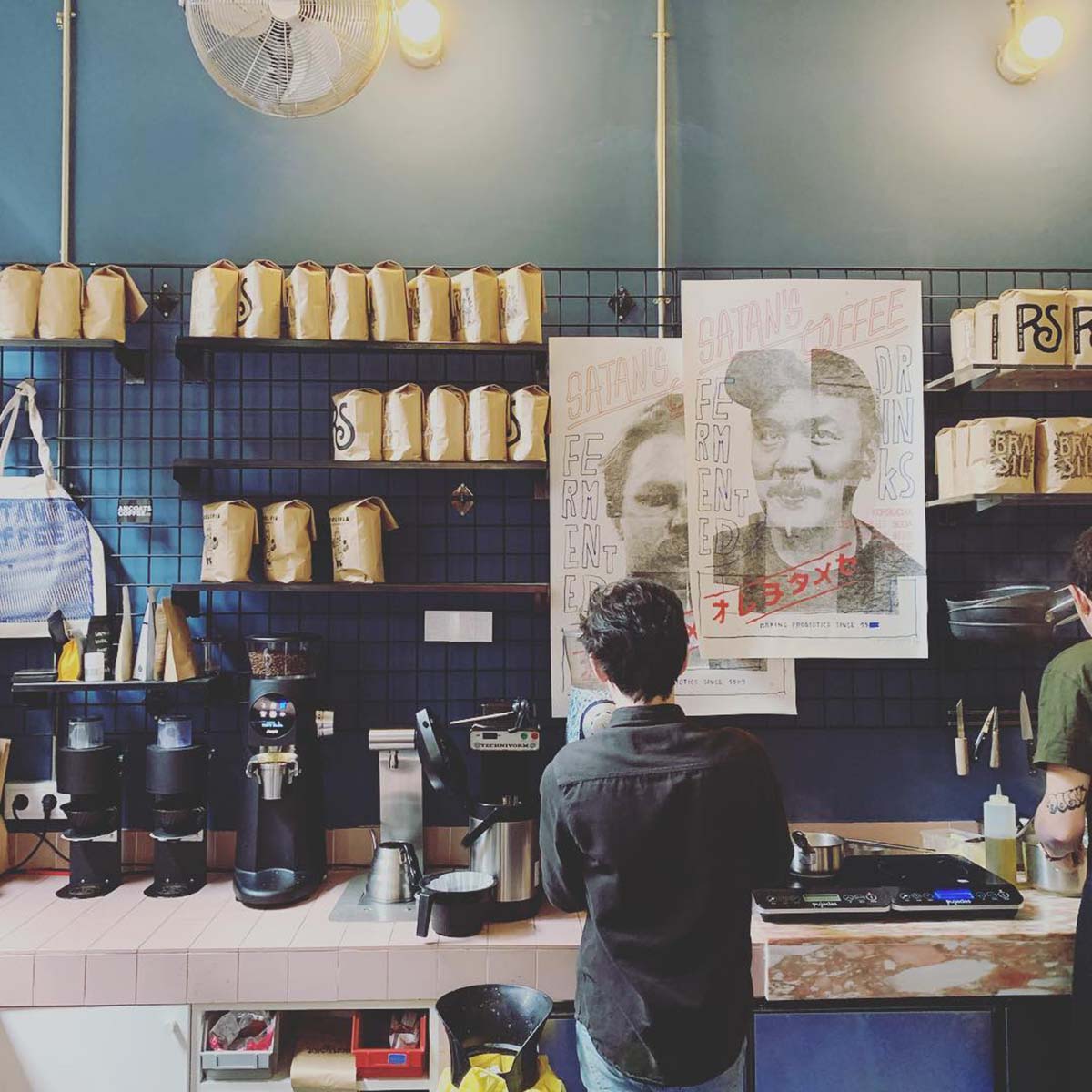 barista making coffee at a coffee shop.