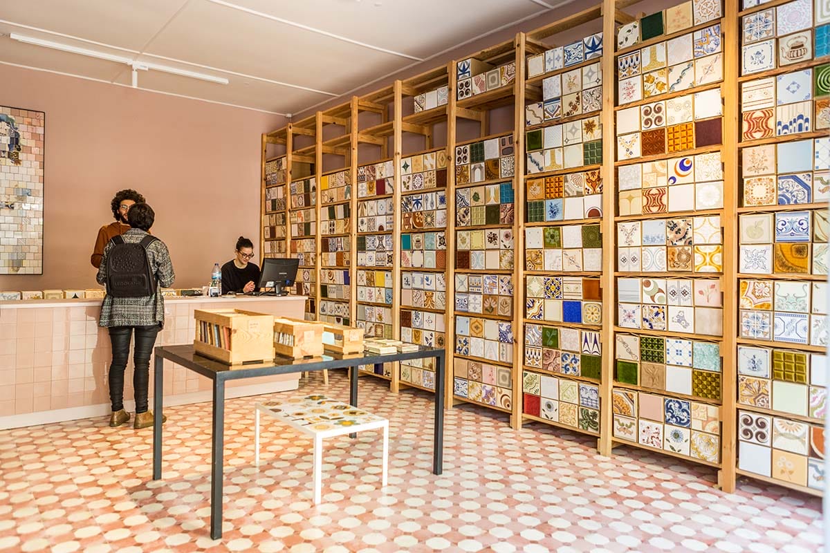 shop with shelves of colorful hand painted tile on the wall.