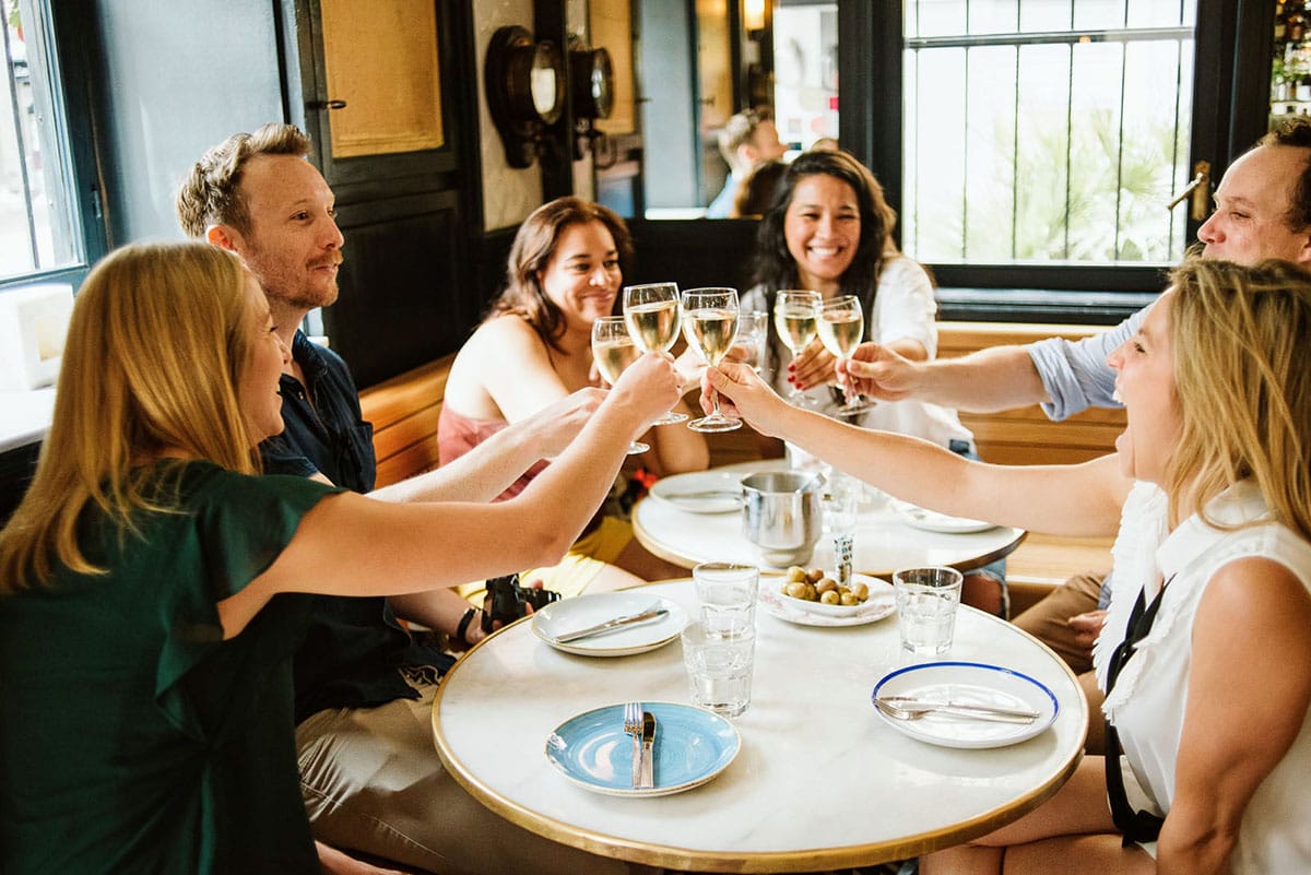 people toasting with cava at a round table.