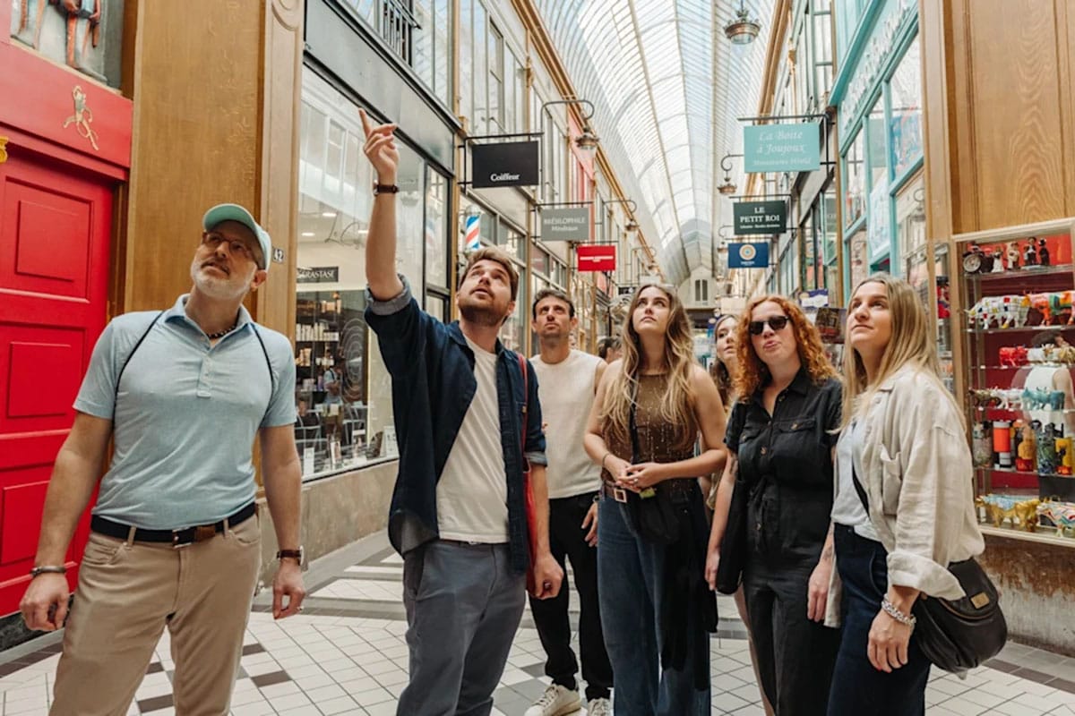 tour guide taking a small group of tourists to a pastry shop in one of Paris' covered passageways.