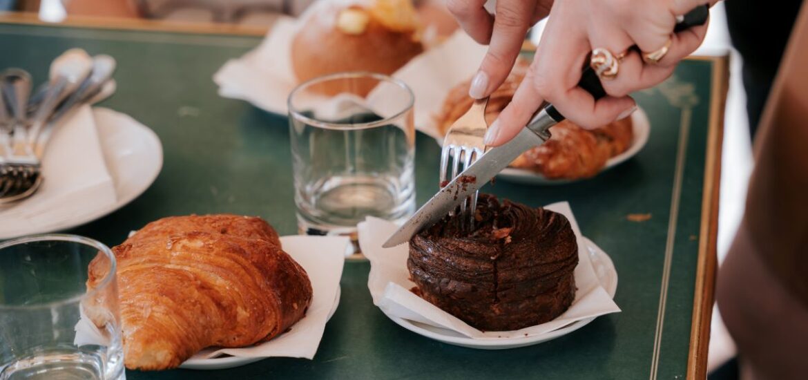 A woman cutting into a freshly baked pastry in Florence.