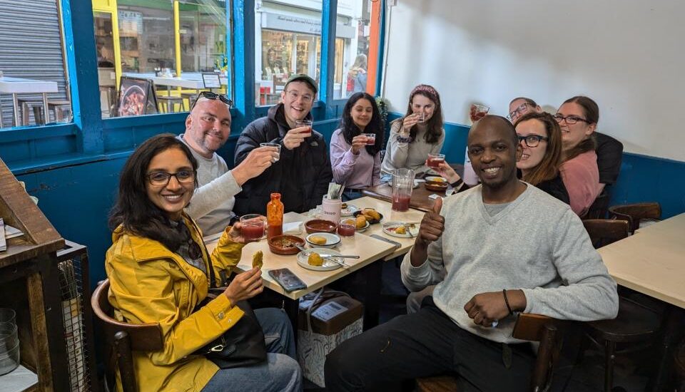 Group of food lovers enjoying a food tour inside a London restaurant