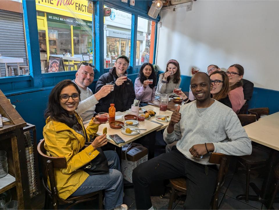 Group of food lovers enjoying a food tour inside a London restaurant