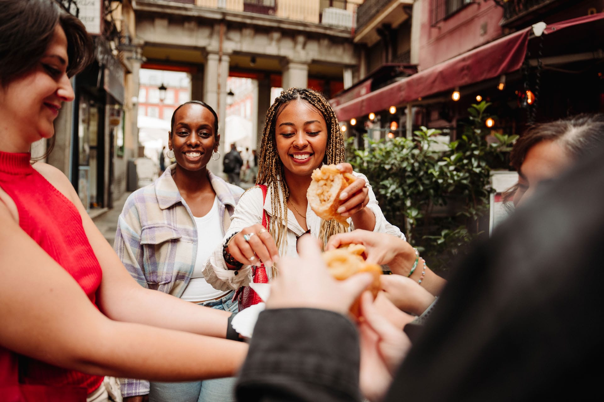 tour guide handing out a plate of food to tourists in Madrid.