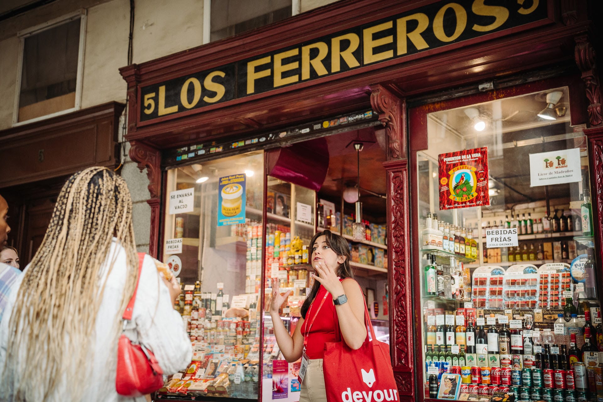 tour guide leading a group of visitors through a food market in Madrid.