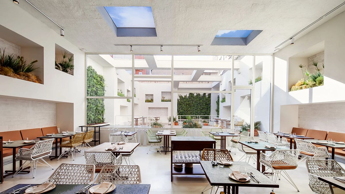 modern-style restaurant with tables, chairs, and windows.