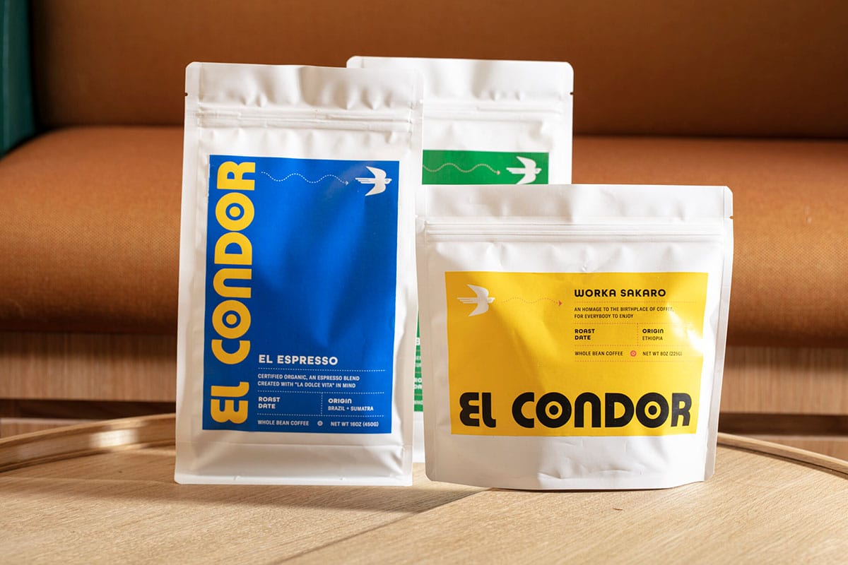 three white bags of roasted coffee with the El Condor logo.