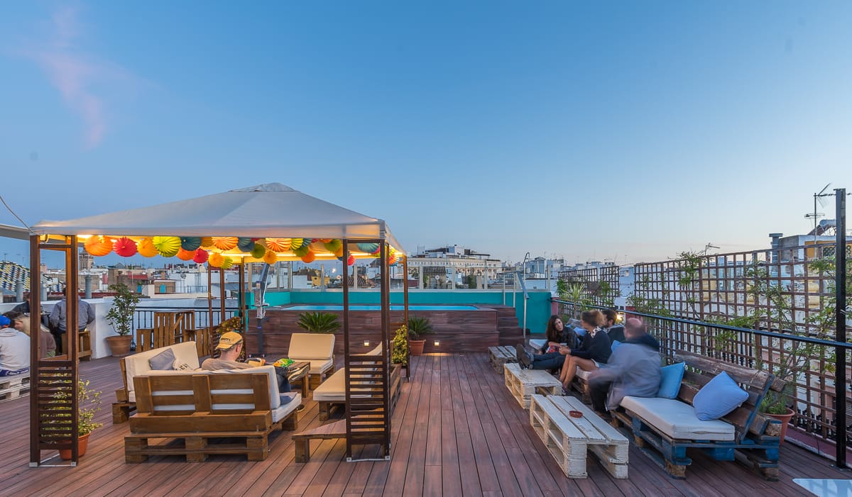 rooftop pool with a gazebo and sofas overlooking the city of Seville.