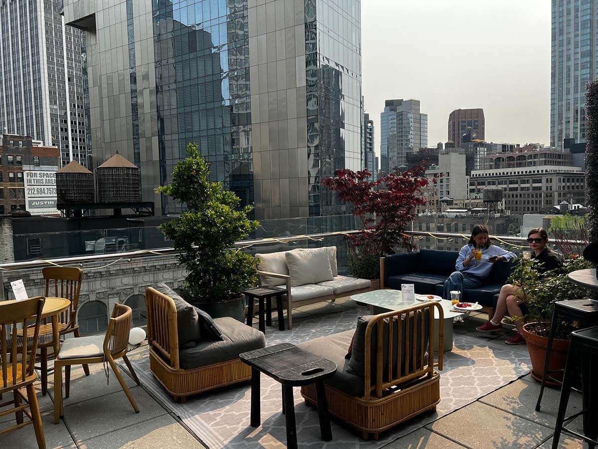 tables and chairs on a rooftop lounge.