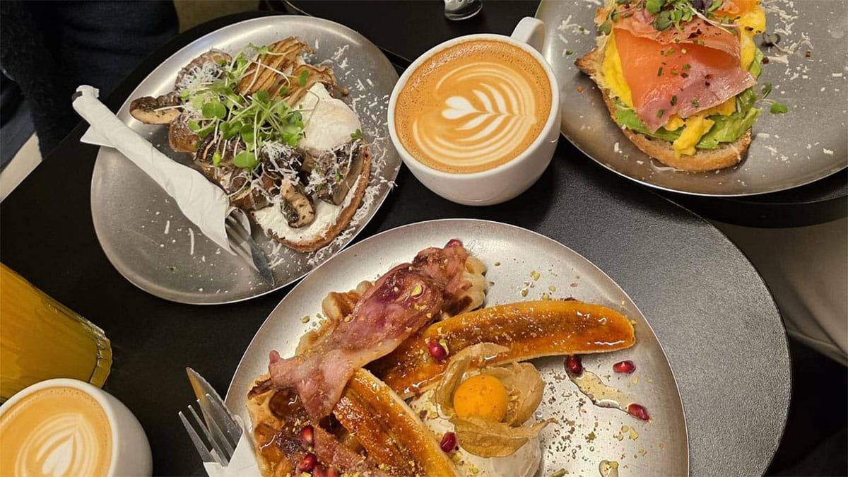 plates of colorful Spanish-Chinese fusion food with lattes.