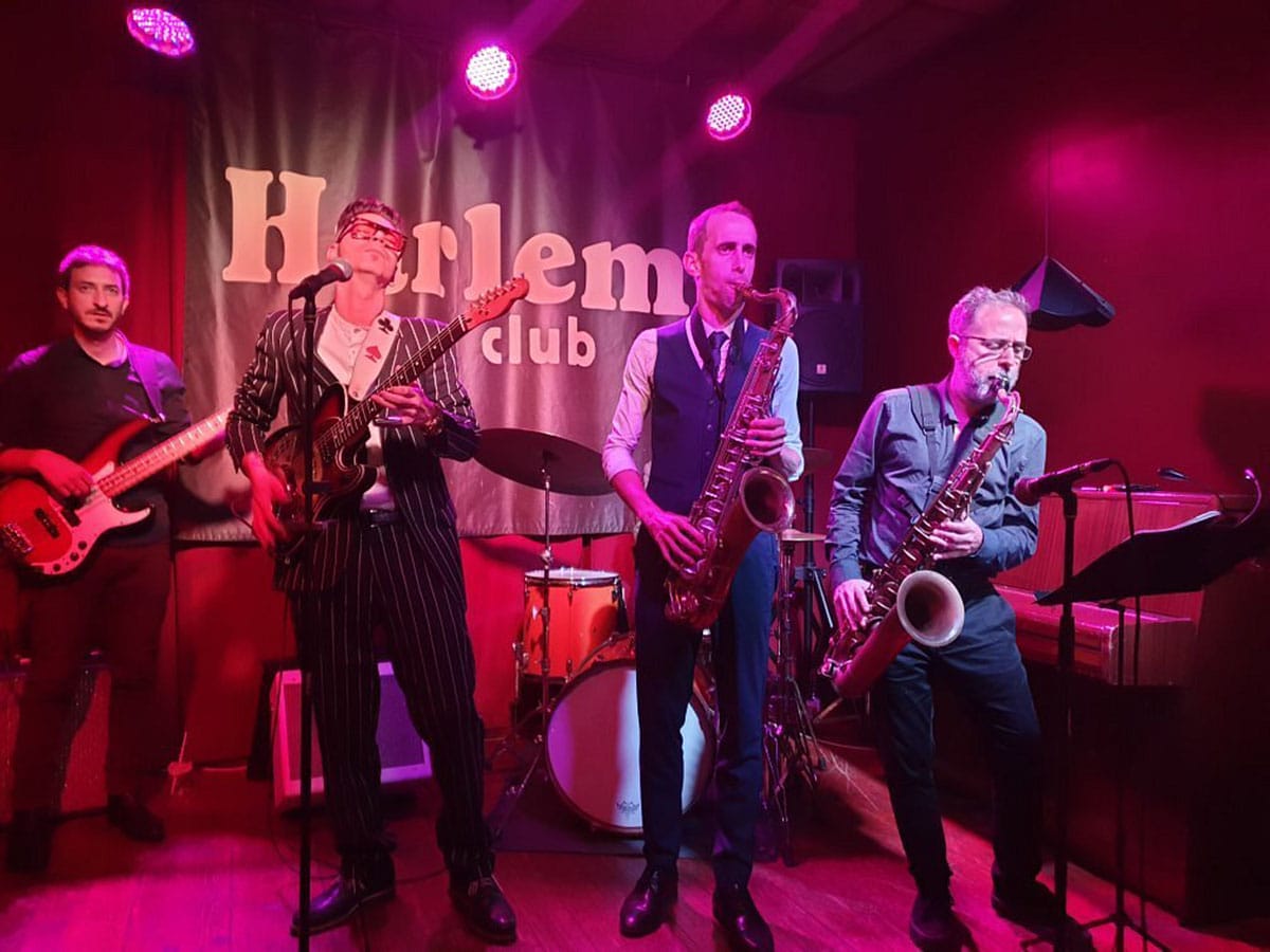 two saxophonists and two guitarists onstage.