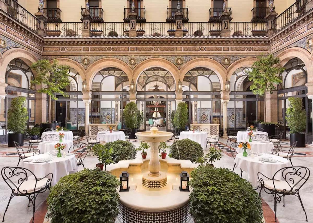 tables and chair at an outdoor terrace in a fancy hotel.