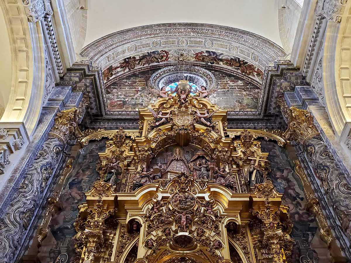orate sculptures and ornamental columns inside a church.