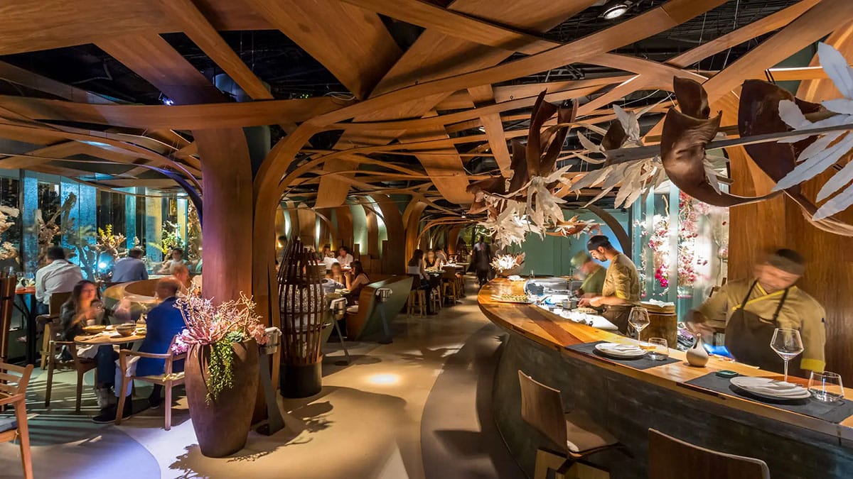 modern restaurant with a unique ceiling and a bar.