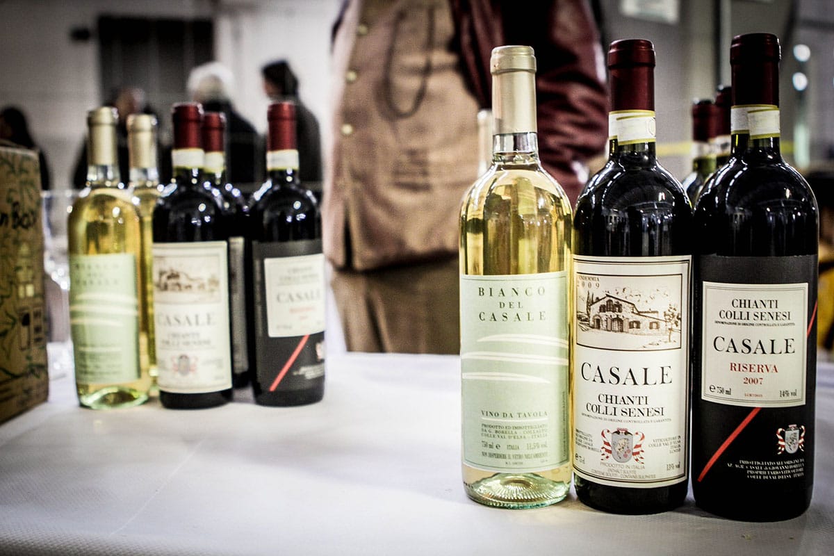 glass bottles of wine on a white table.