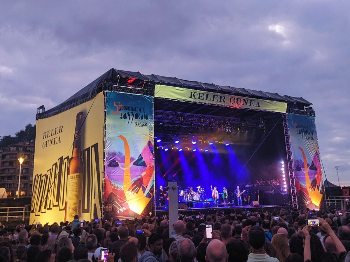jazz performers on stage at Zurriola Beach with a large crowd watching.
