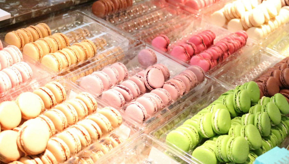 plastic trays of colorful pastel macarons.
