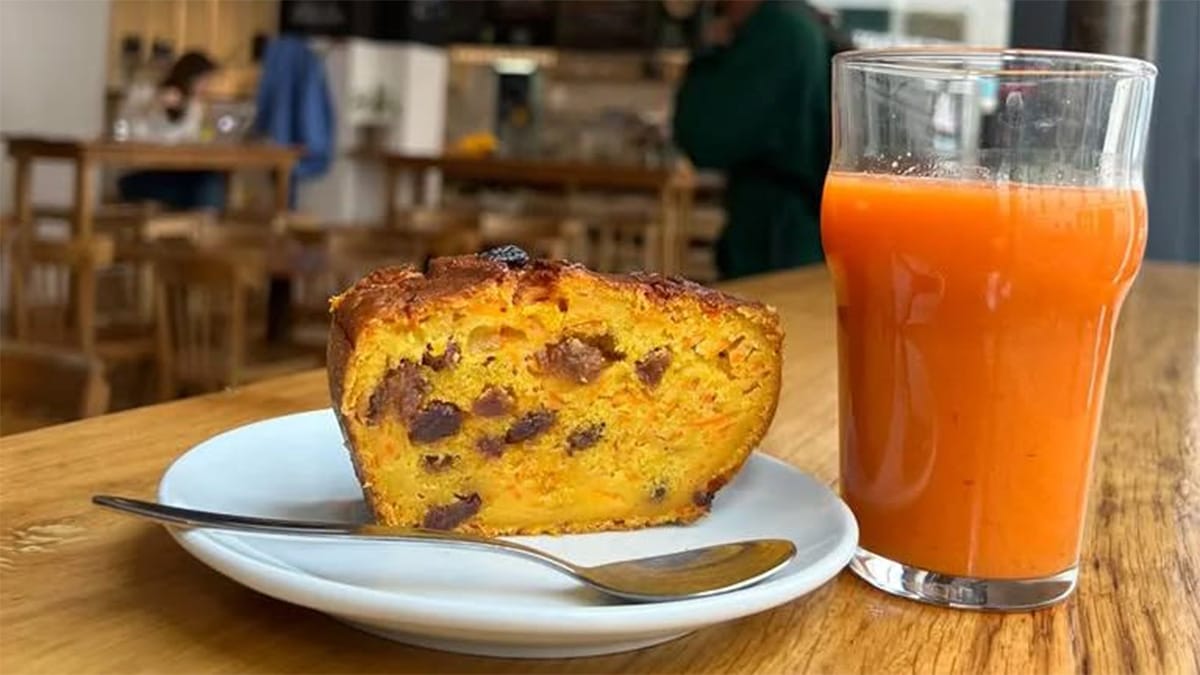 sliced raisin bread with a glass of blood orange juice.
