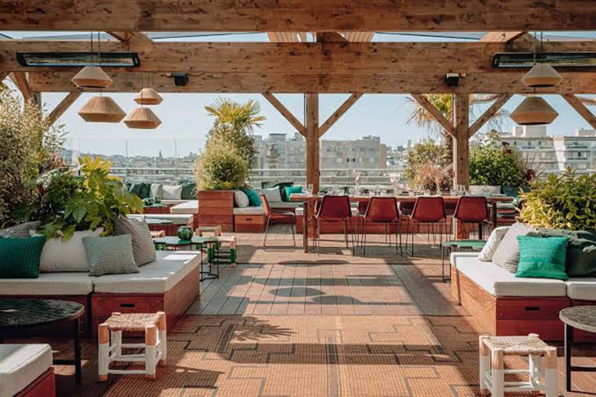 chairs and sofas on a rooftop bar in Paris.