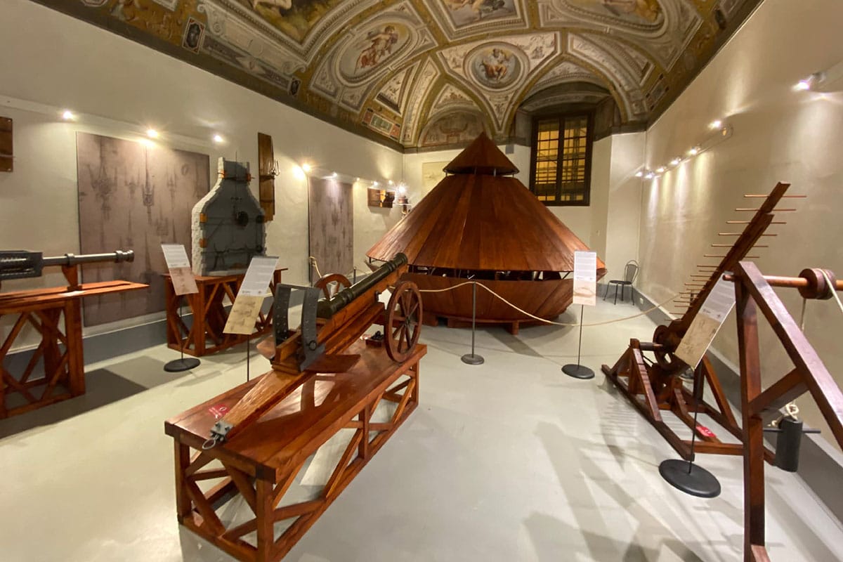 wooden inventions including a cannon and tank in a museum.