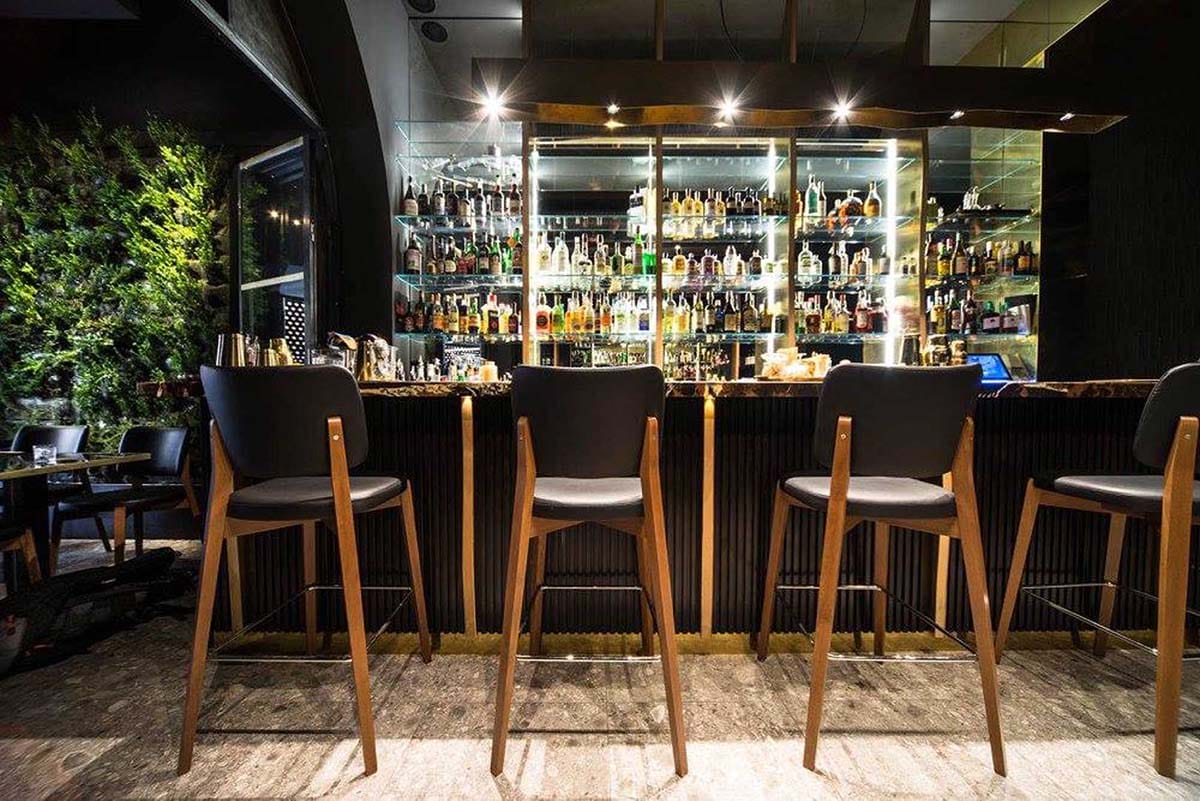 modern style bar with stools and a granite counter.