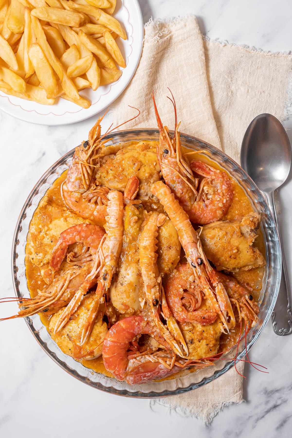 glass bowl of shrimp and chicken in broth.