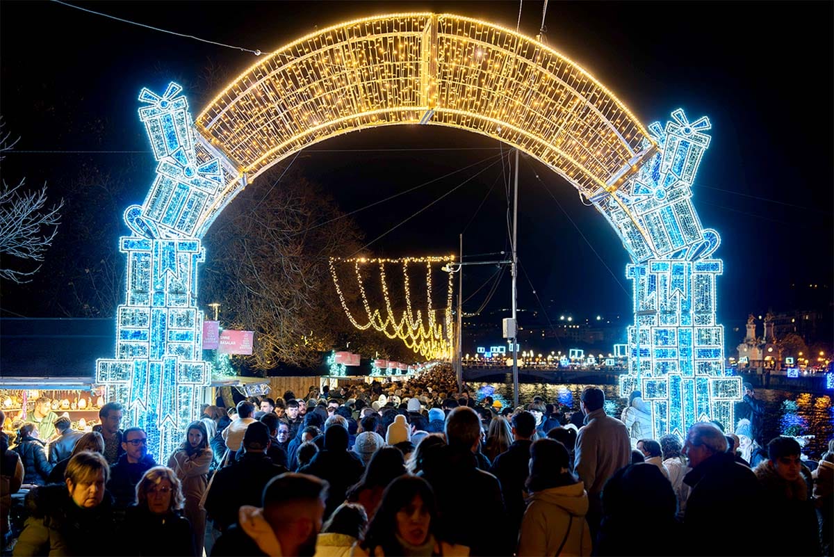 illuminated archway entrance to a Christmas market.