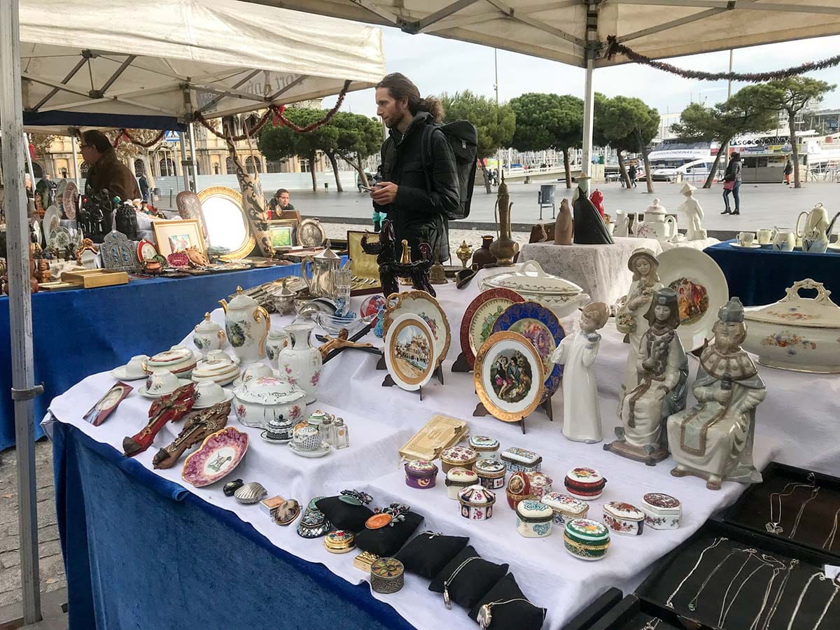 tables under portable tents spread with china, jewelry, and other antique souvenirs.