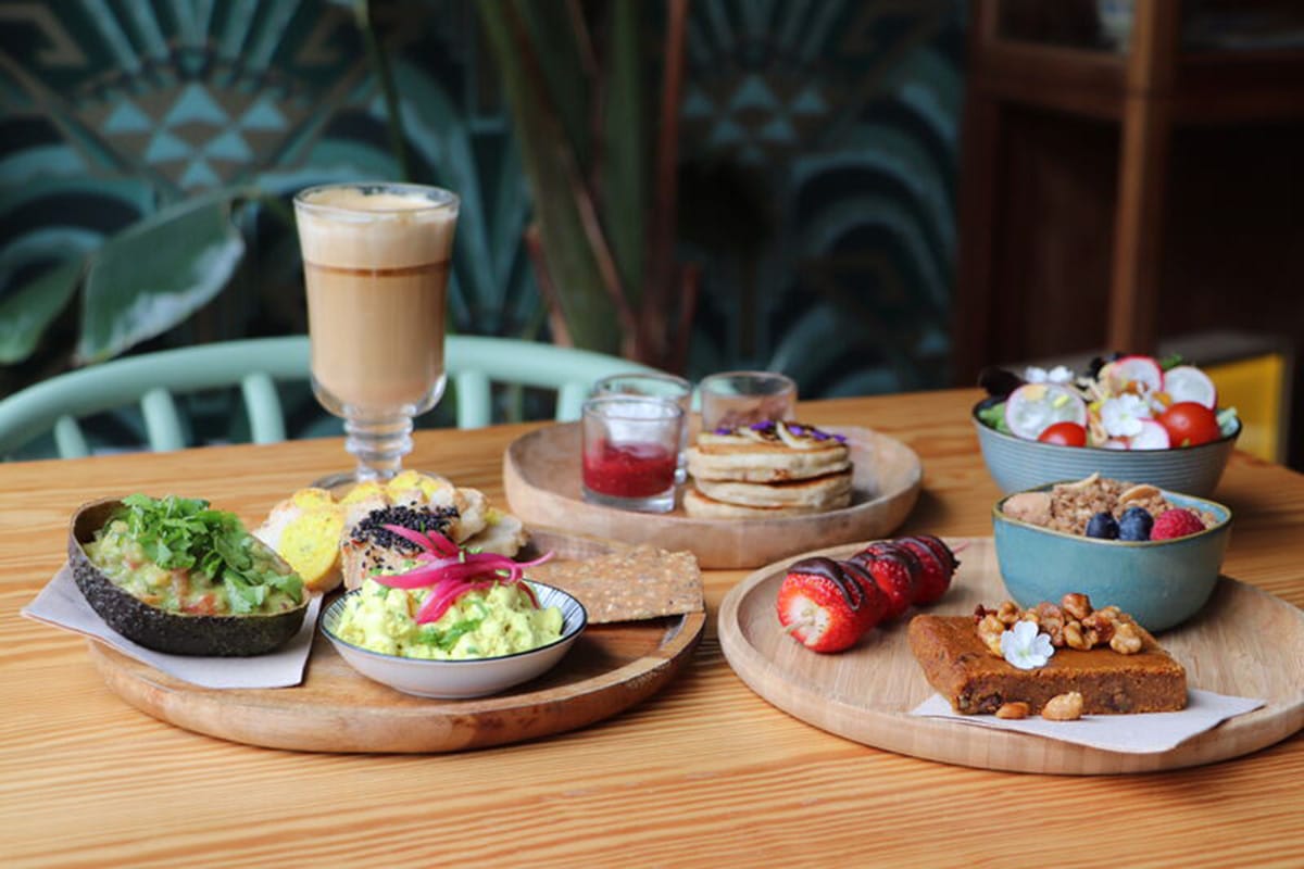 plates of sweet and savory vegan food with garnishes.