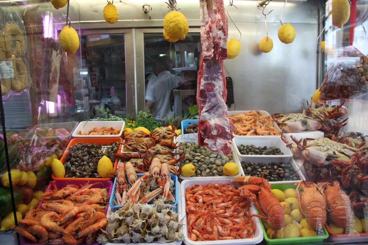 bins of fresh seafood in a restaurant kitchen.