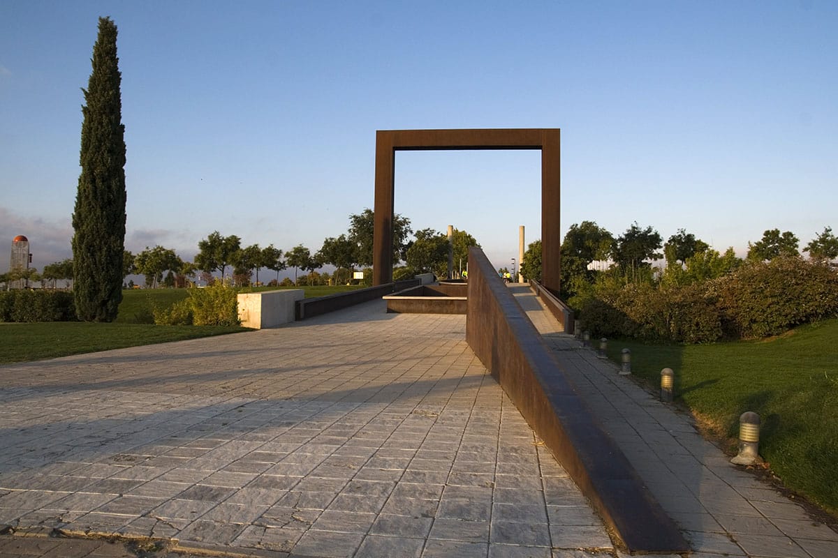 a walkway over a river at a park.