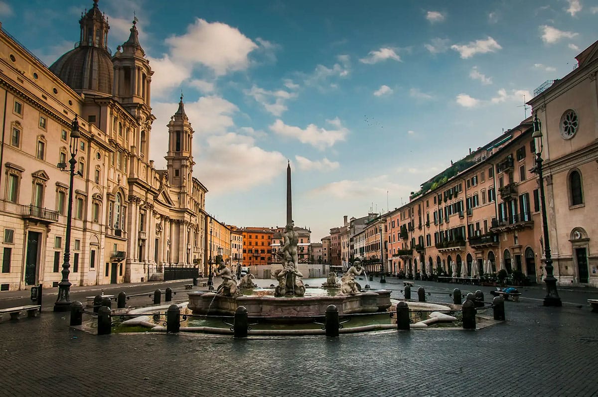 A dramatic Baroque fountain in the center of a historic Roman plaza.