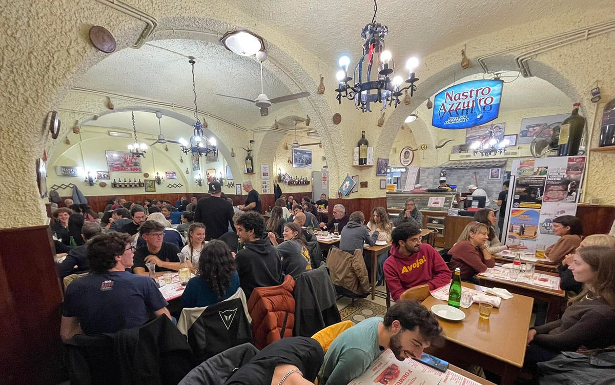 tables of people eating at a pizzeria.