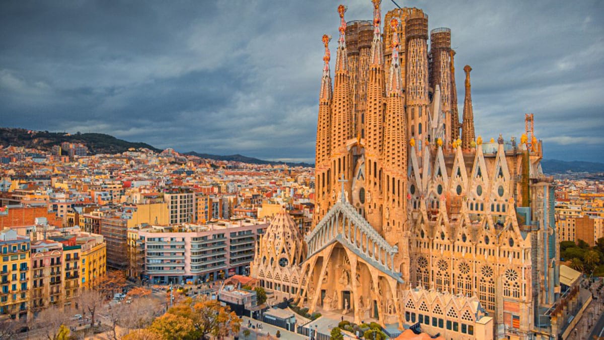 unique Spanish cathedral with the city of Barcelona in the background.